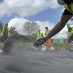PICS team applying pattern imprinted concrete outdoors in high-vis gear.